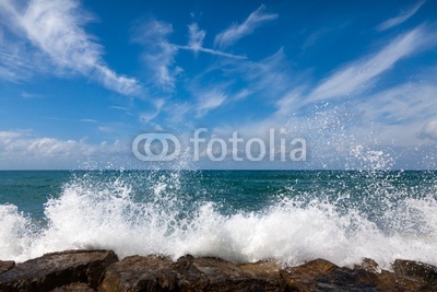 The waves breaking on a stony beach