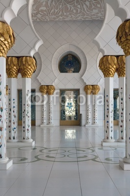 Mosque interior. White columns adorned with gold.