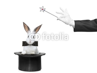 A rabbit in a hat and hand holding a magic wand