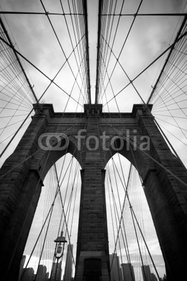Black and white upward view of Brooklyn Bridge