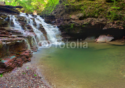 Tranquil waterfall scenery in the middle of green forest