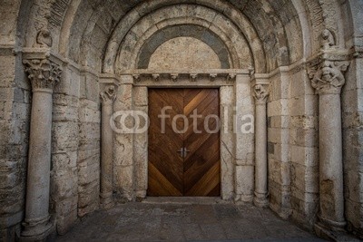 Wooden door in ancient archway