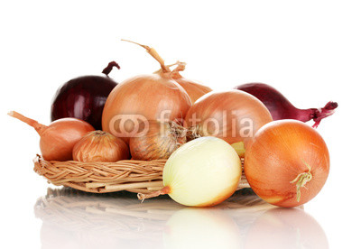 Ripe onions on wicker cradle isolated on white