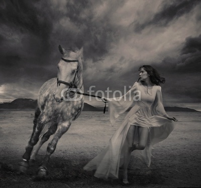 Fine art photo of a young beauty running with a horse