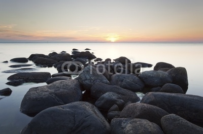 Rocks leading to open sea. Wide angle photo