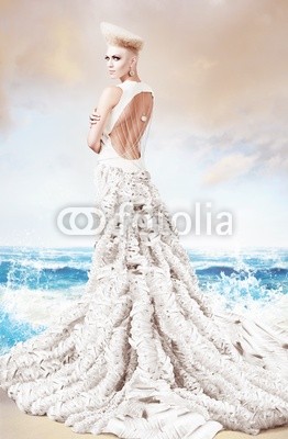 woman in long white dress on sea beach