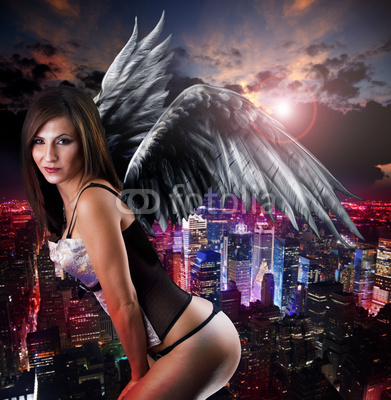 Woman with angel’s wings against city night skyline