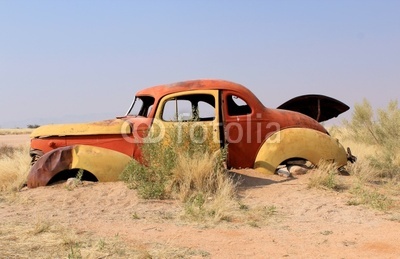 Old and rusty car wreck at the last gaz station before the Namib