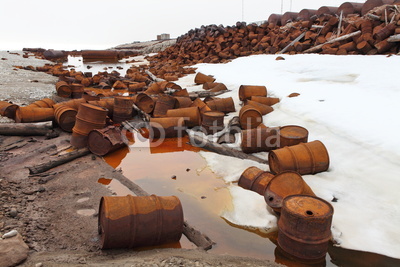 Rusty fuel and chemical drums on Arctic coast