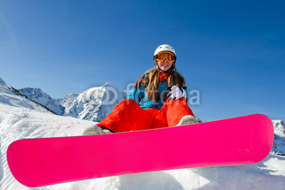 Winter vacation - portrait of young snowboarder girl
