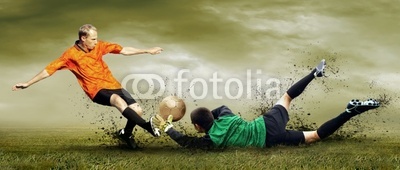 Shoot of football player and goalkeeper on the outdoors field